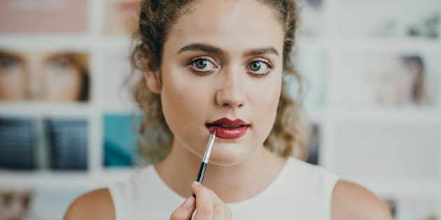Lady applying lipstick 
