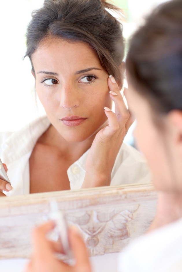 Lady looking at herself in mirror